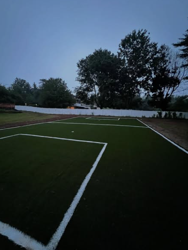 Backyard after installation — finished synthetic turf sports field